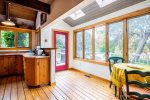 Kitchen access onto the back deck with gas grill and outdoor dining